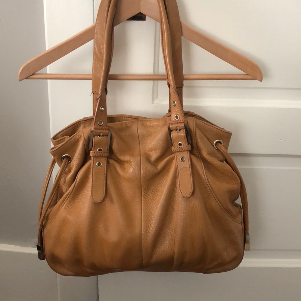 Pour La Victoire leather purse with buckles.